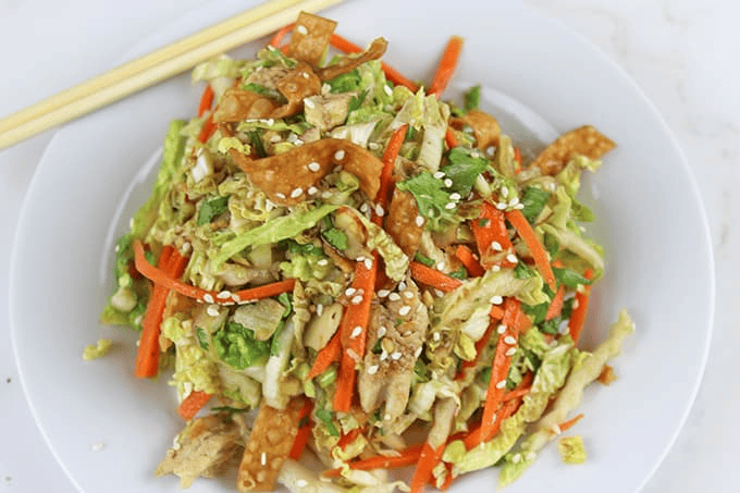 Plated chicken salad with chopsticks