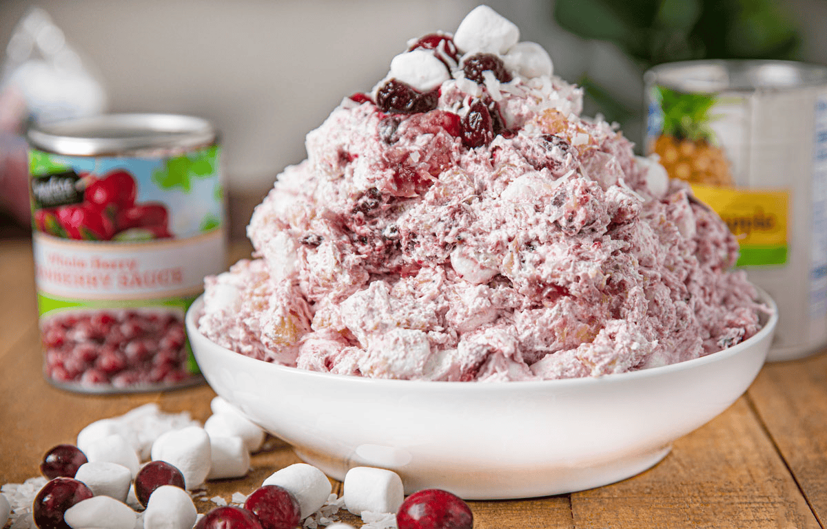 Bowl of cranberry salad with cranberries and marshmallows on the side