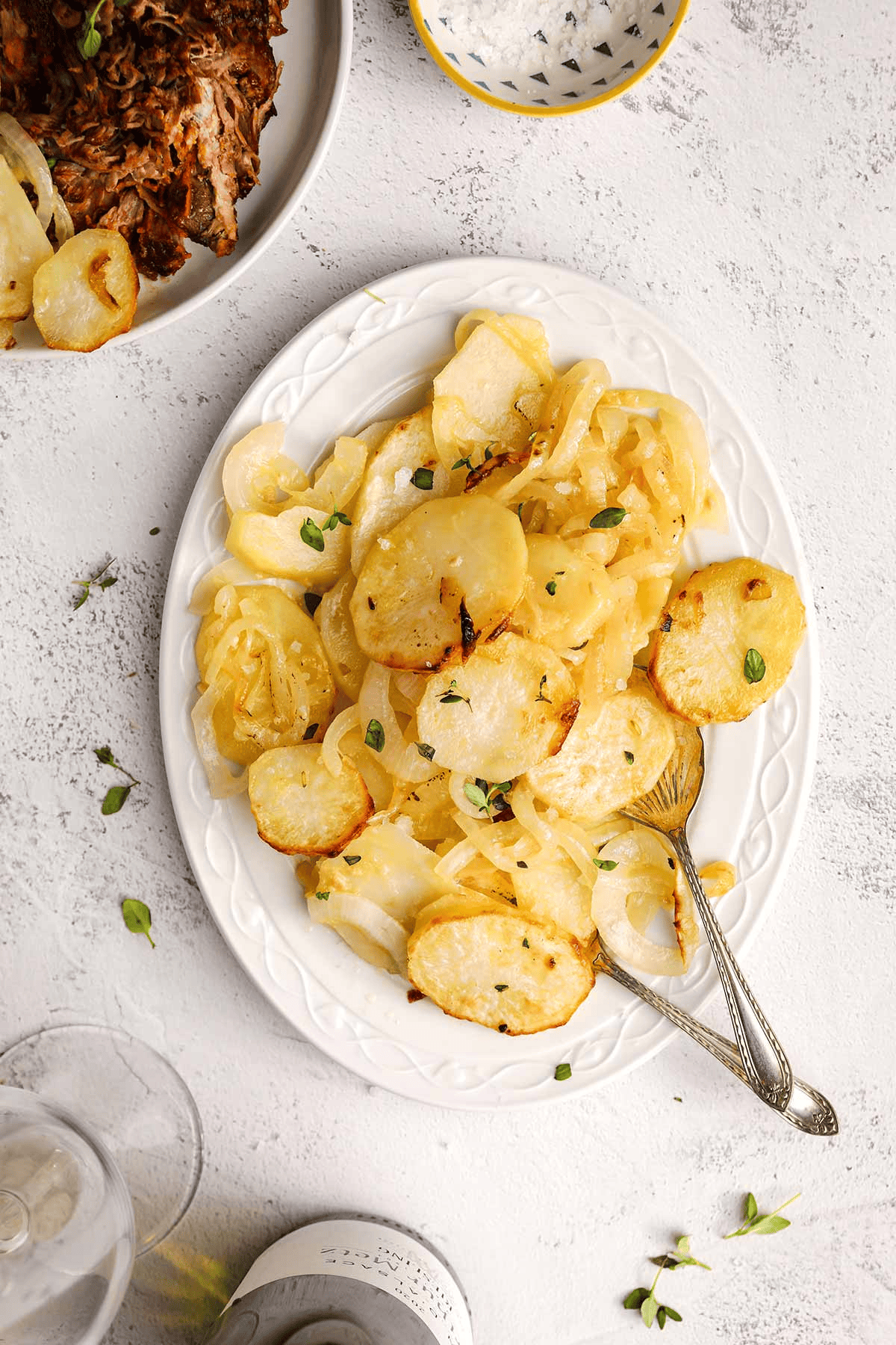 White platter of sliced potatoes and onions