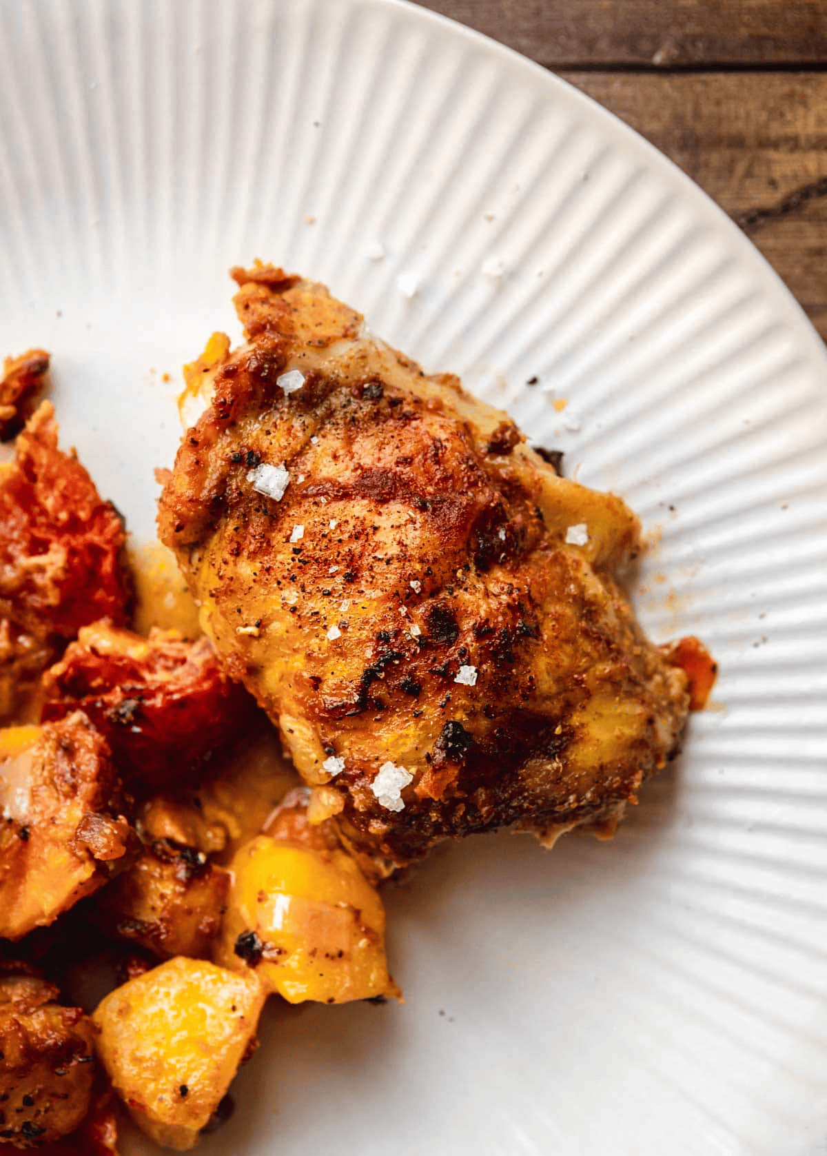 Plated chicken, potatoes, and mangoes