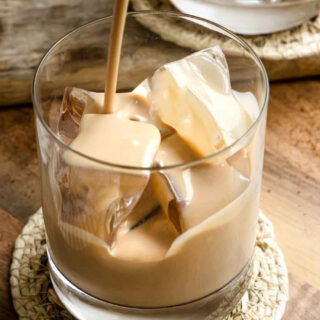 Irish cream being poured into a rocks glass