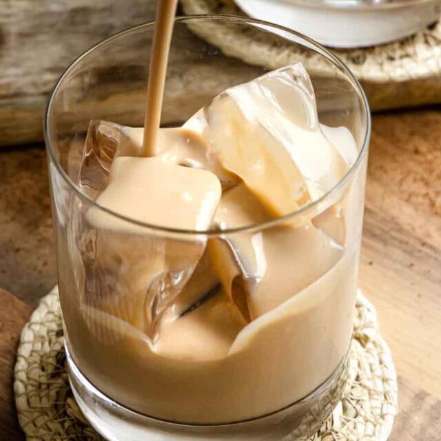 Irish cream being poured into a rocks glass