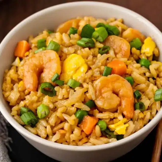 Bowl of rice with veggies and shellfish.