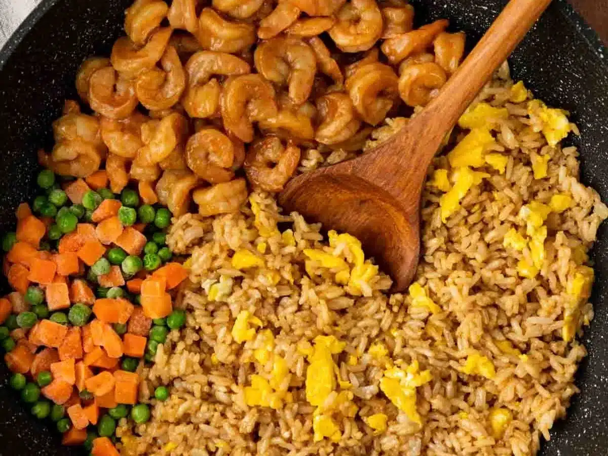 Pan with rice, egg, frozen veggies, and seafood.