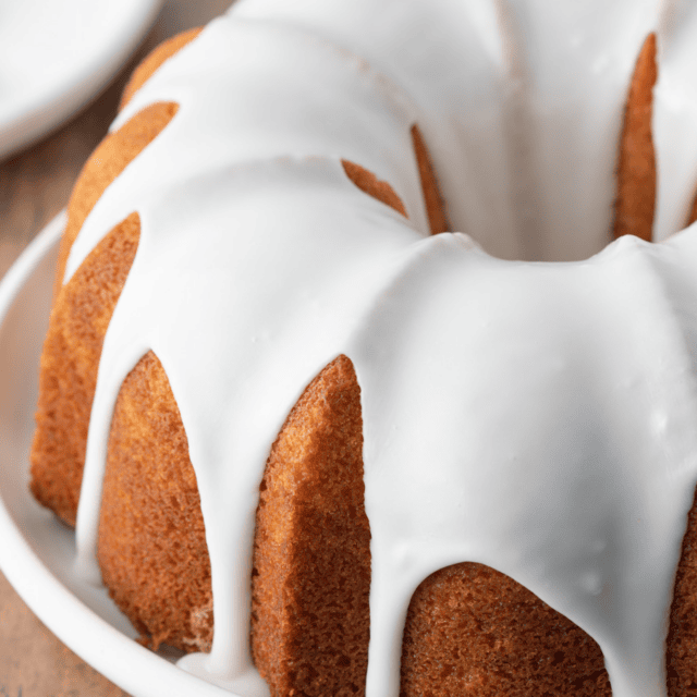 Round cake drizzled with white glaze frosting