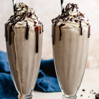 Frozen shake with whipped cream and chocolate syrup garnish.