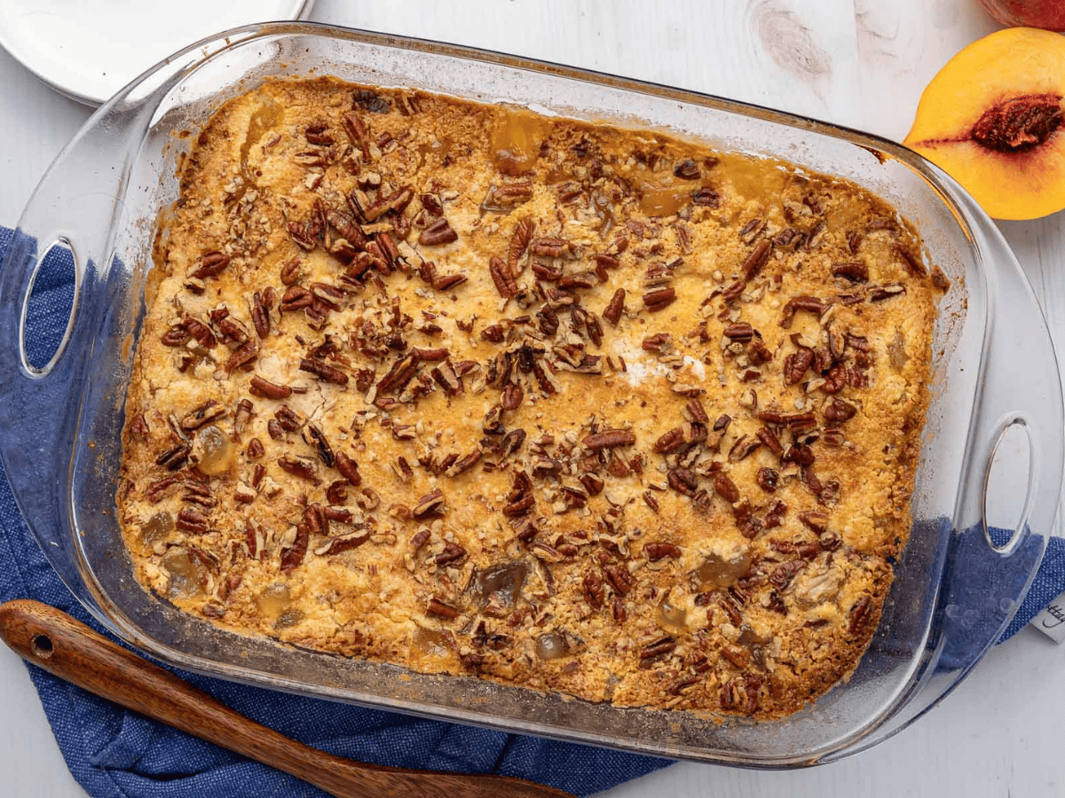 Finished dessert in glass baking dish on a white counter top with a blue dish rag.