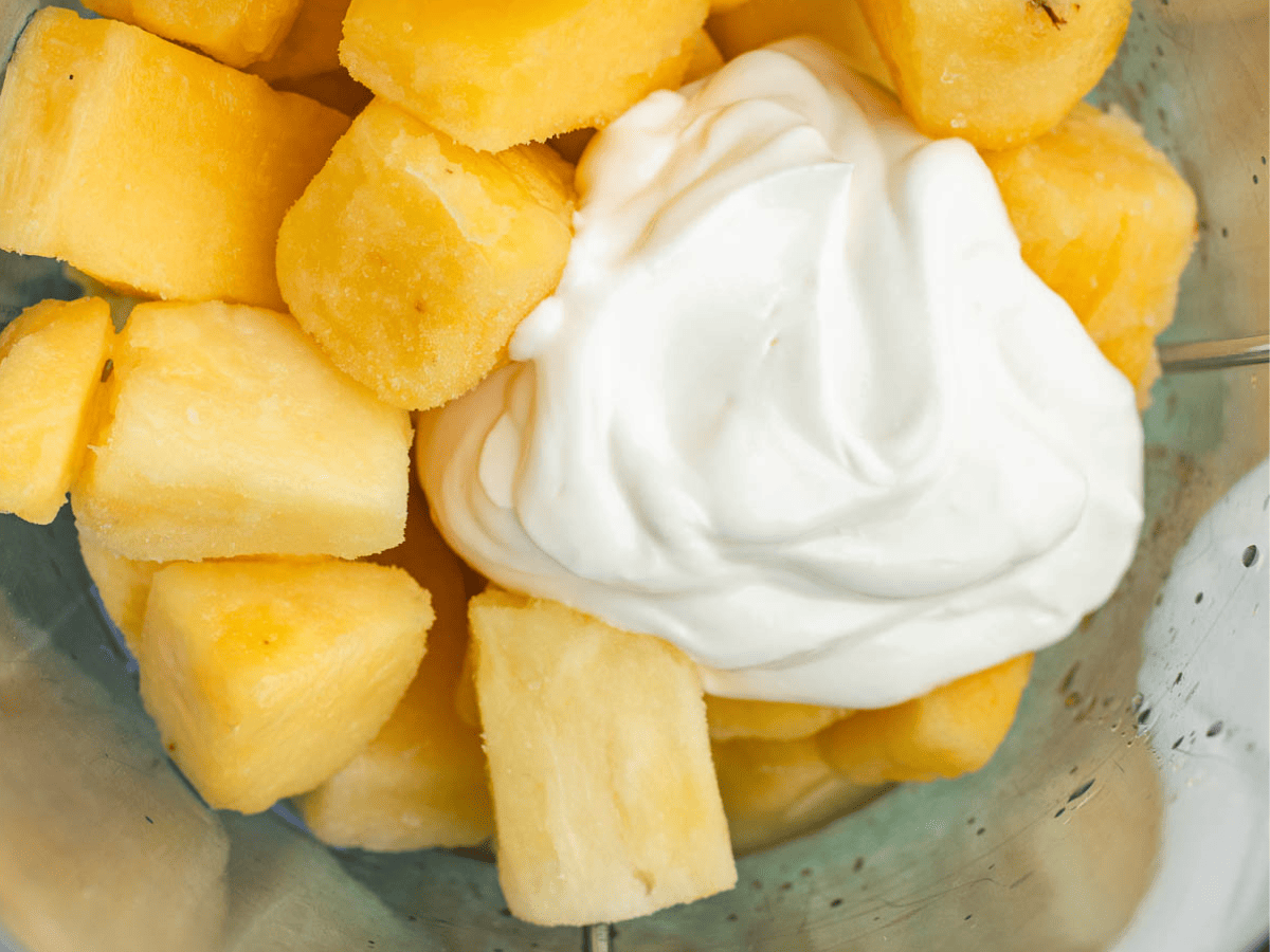 Pineapple chunks and yogurt in blender.