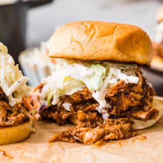 Shredded meat sandwich with coleslaw on bun.