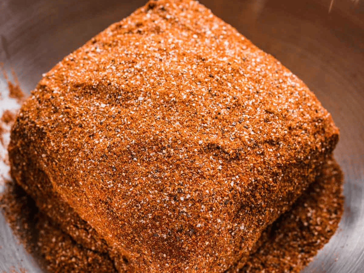 Pork shoulder covered in dry rub.