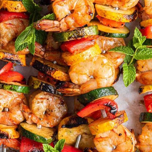 Shellfish shiskabobs on serving plate.