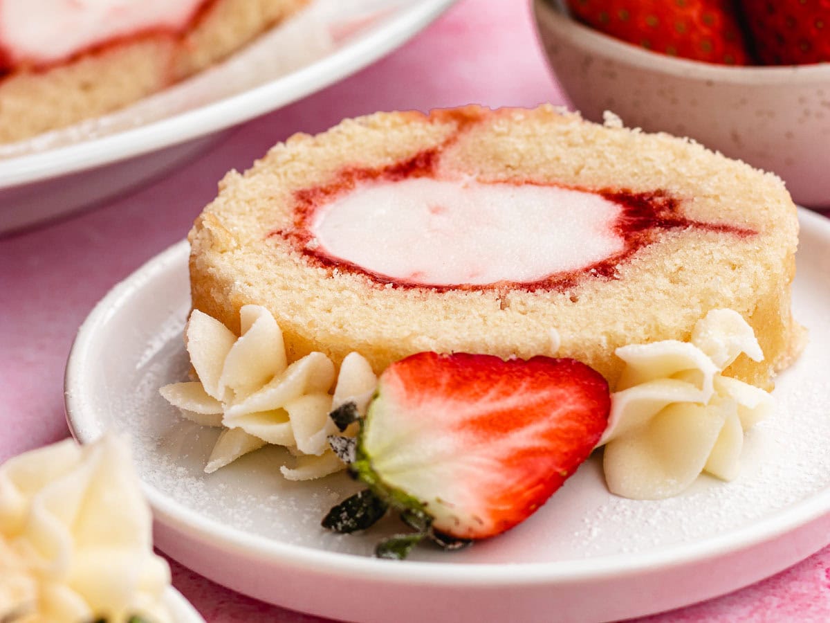 Slice of cake roll on dessert plate.