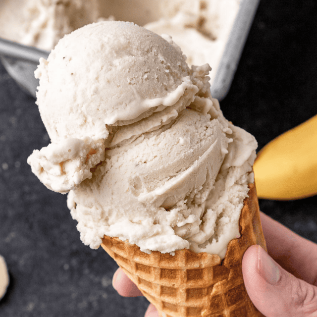Two scoops of ice cream in cone.