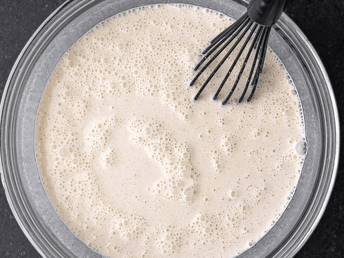 Dairy and other ingredients mixed together in bowl.