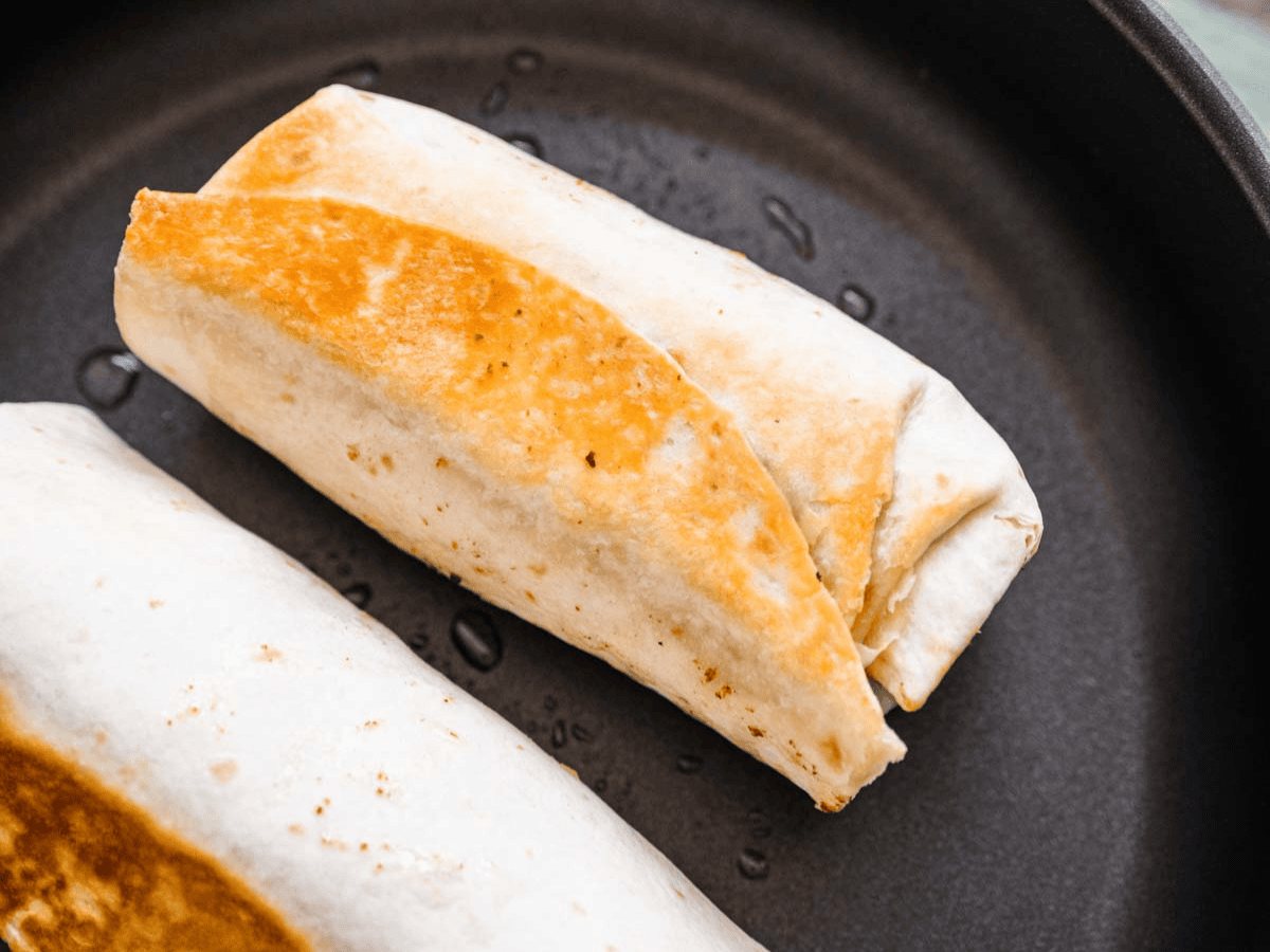Tortilla wrap browning in pan.