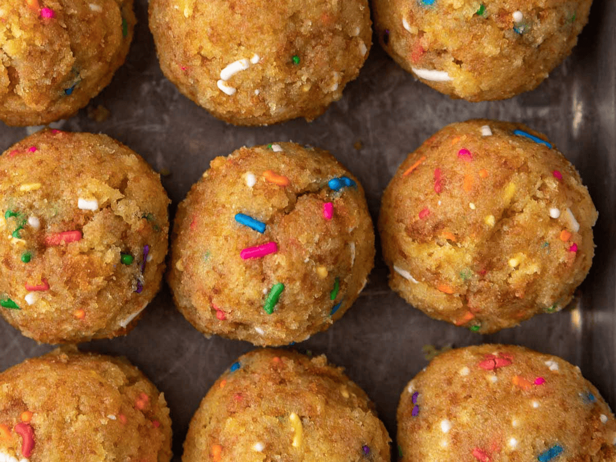 Tiny balls of cake on a baking sheet.