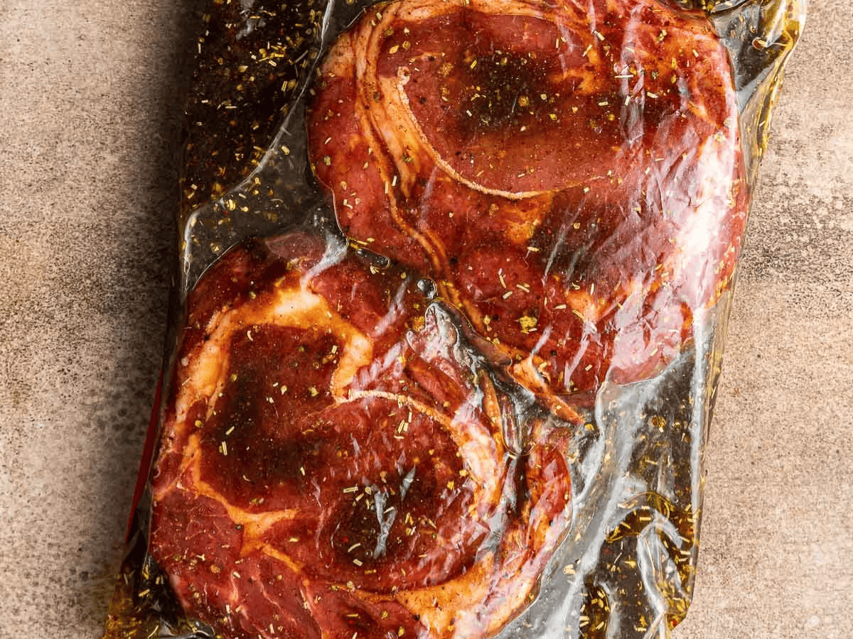 Ribeyes marinating in ziplock bag.
