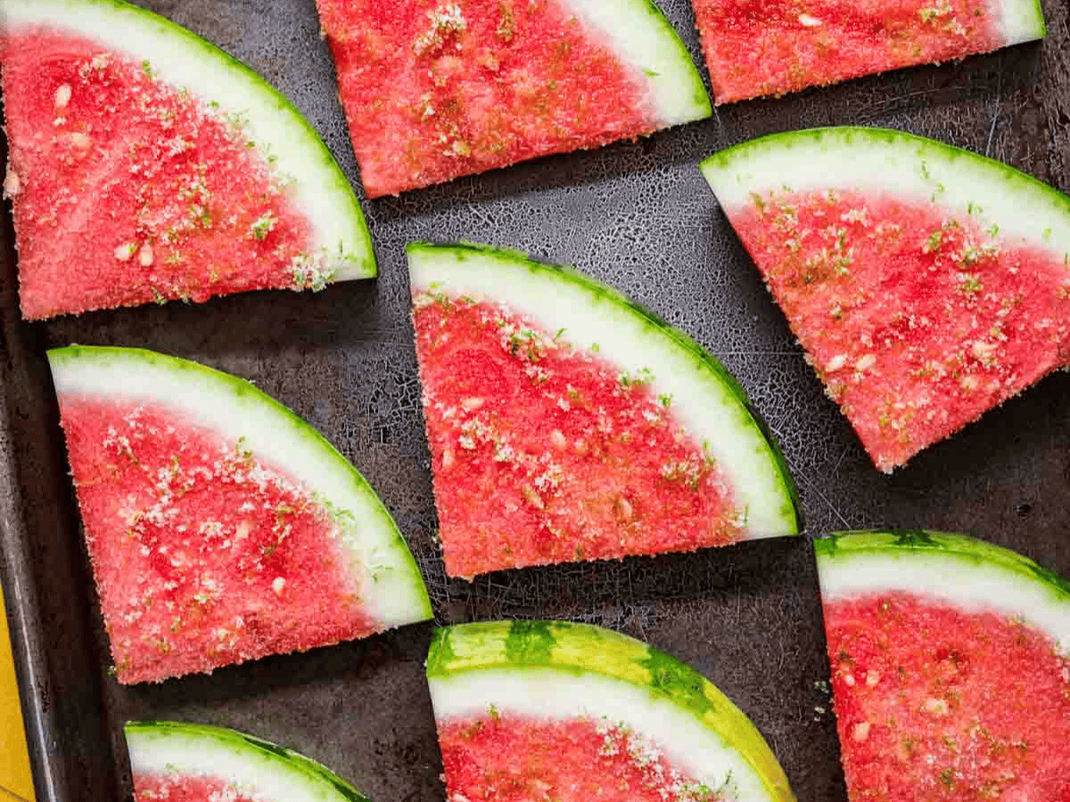 Seasoned melon wedges on baking sheet.