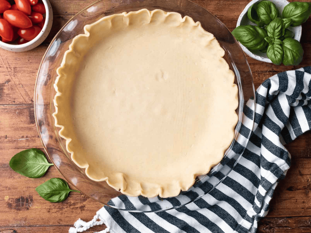 Unbaked pie crust in glass pie dish.