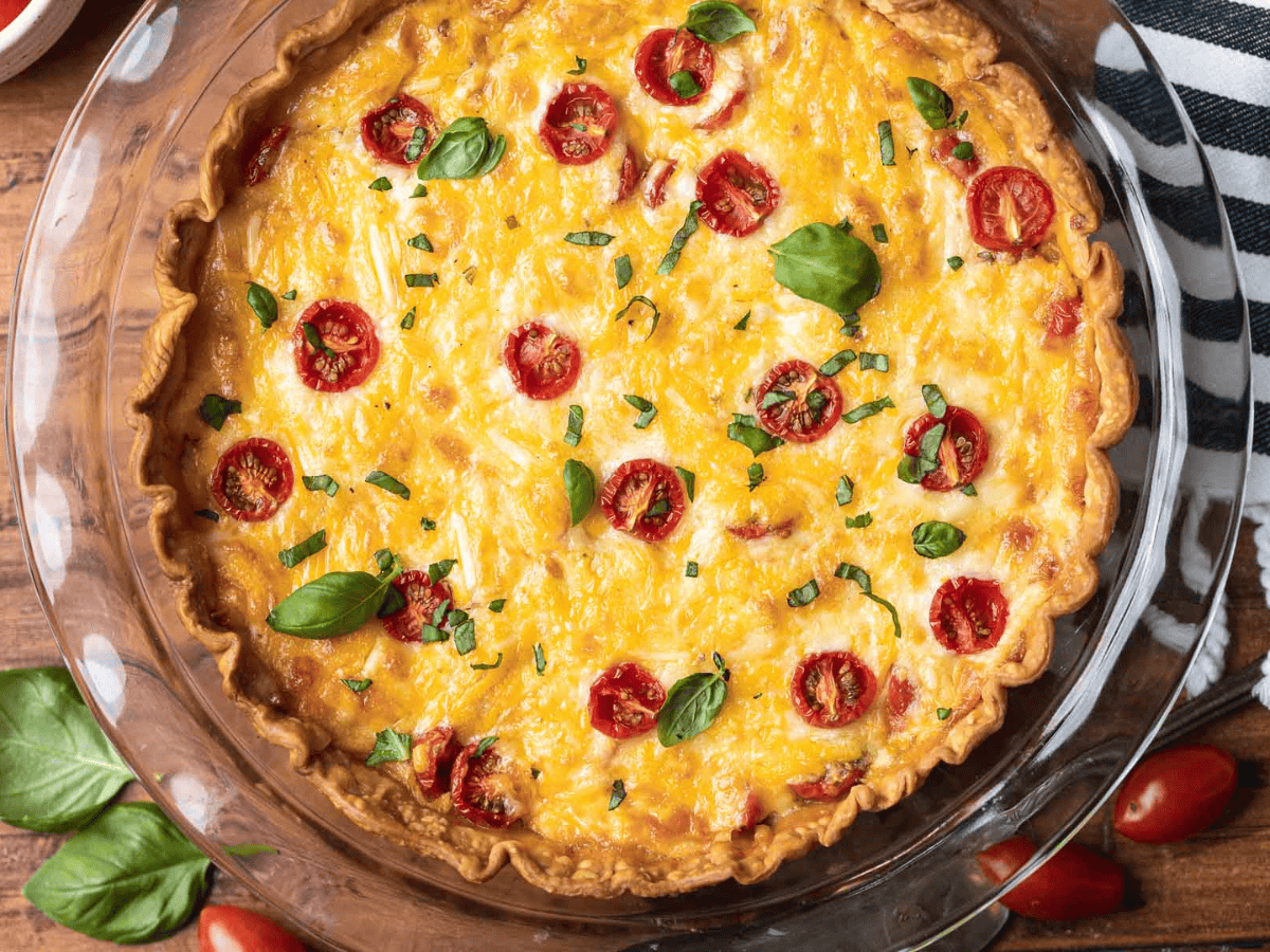 Cooked savory pie in a glass pie dish.