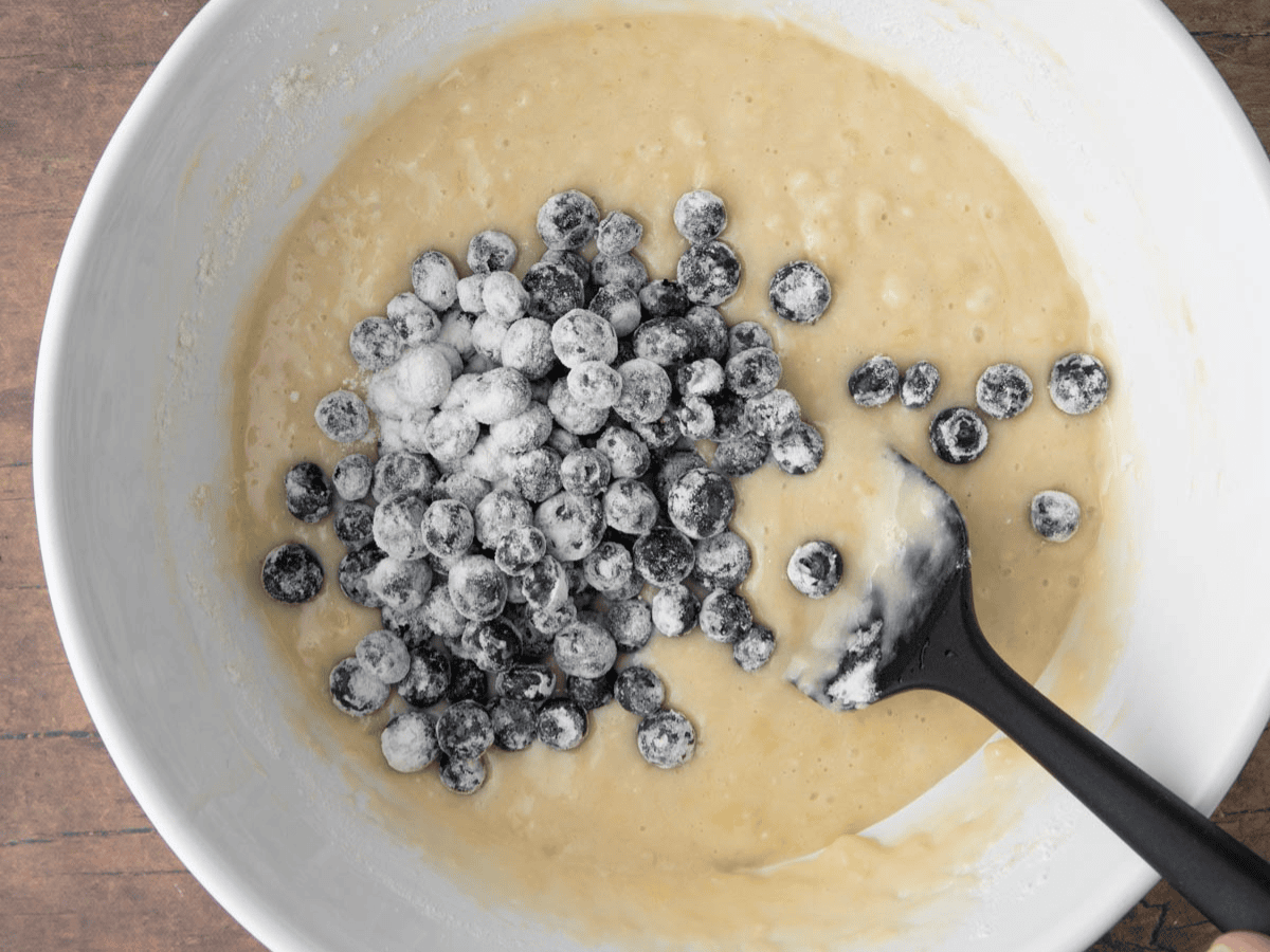 Berries being added to muffin batter.