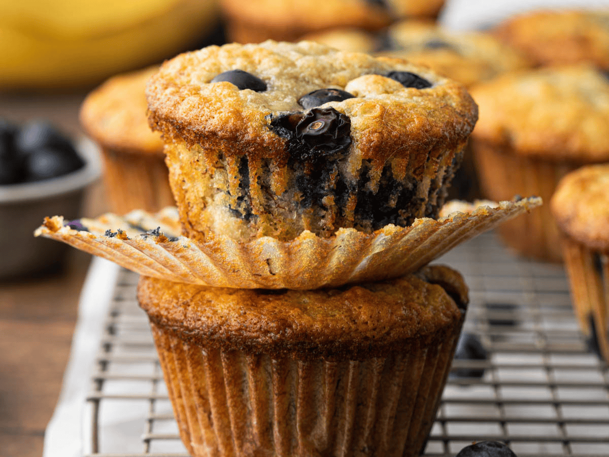 Two breakfast muffins sitting on top of each other.