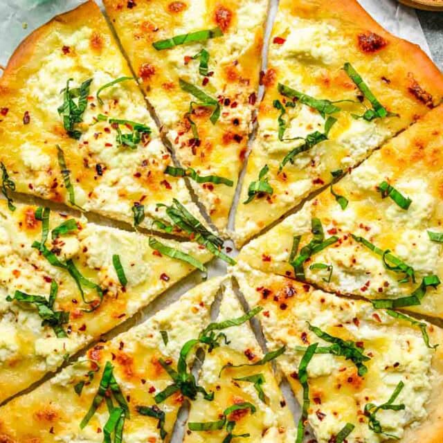 Pizza with basil chiffonade topping.