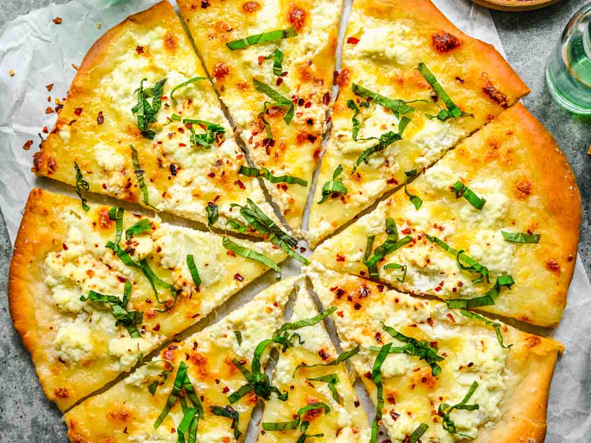 Pizza with basil chiffonade topping.