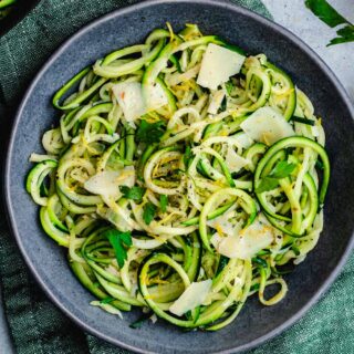 Bowl of zoodles with shaved Parmesan.
