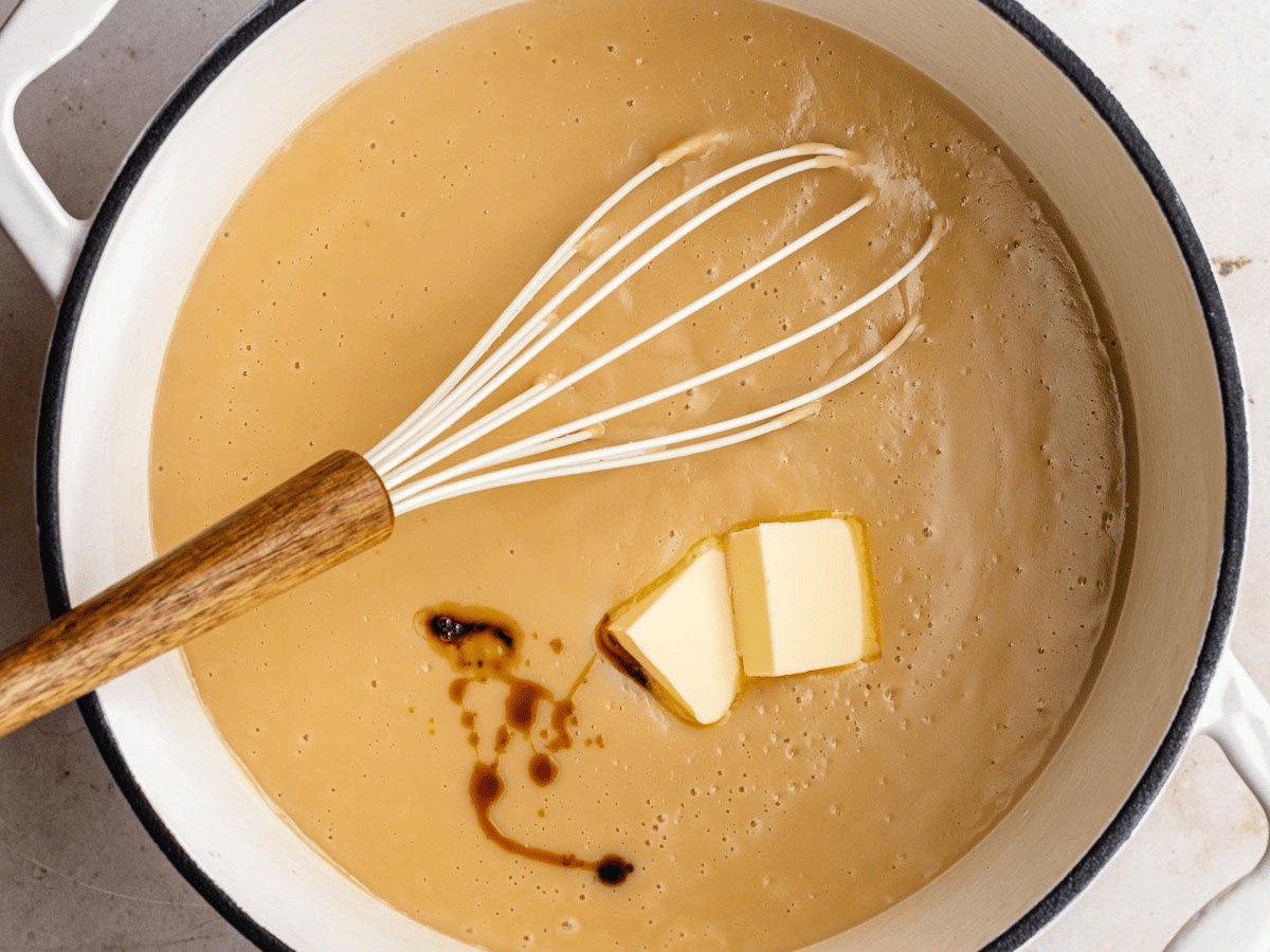 Whisk mixing butter, vanilla, milk, sugar, cornstarch, and egg yolks.