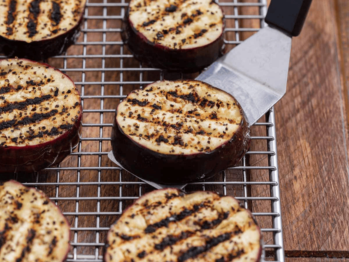 Grilled aubergine cooling on rack.