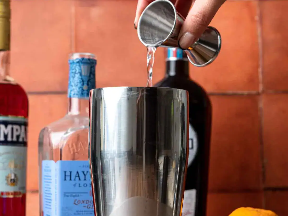 Gin being poured into shaker.