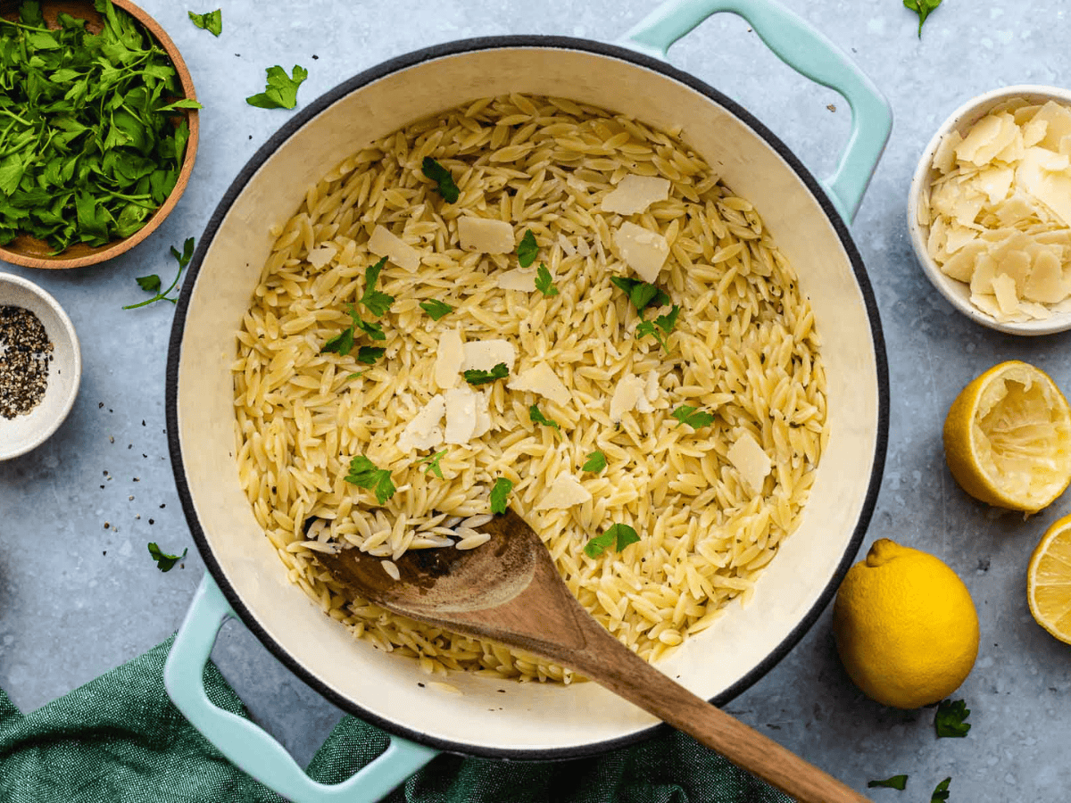 White pot with blue rim containing ingredients for pasta dish already mixed in.