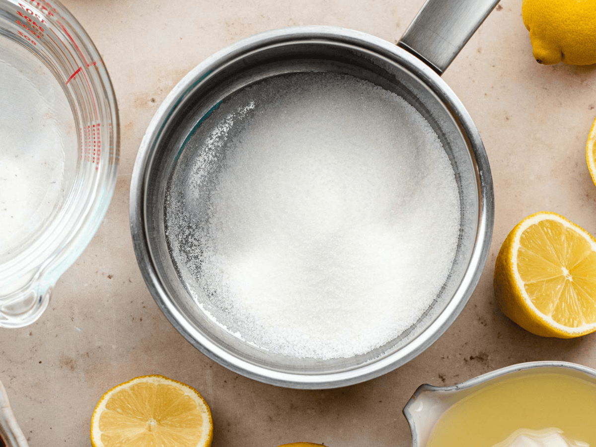 Sugar being melted in a silver pan.