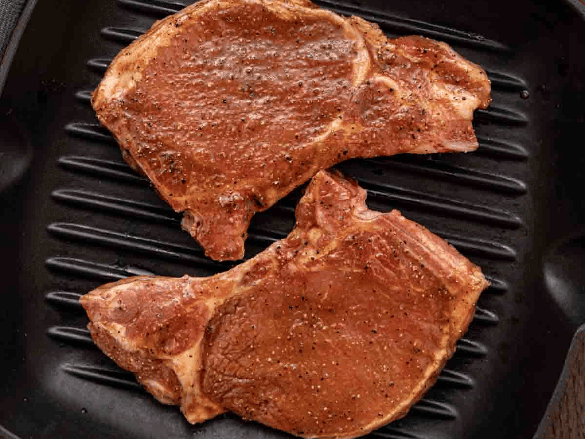 Marinated pork chops, waiting to be grilled.