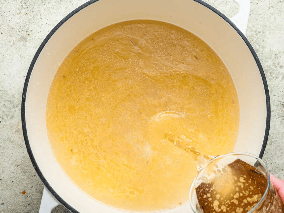 Chicken based broth in large pot.