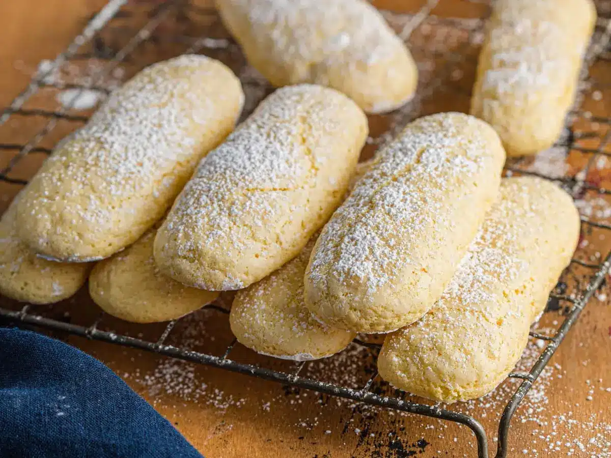 baked lady finger cookies piled on wire rack