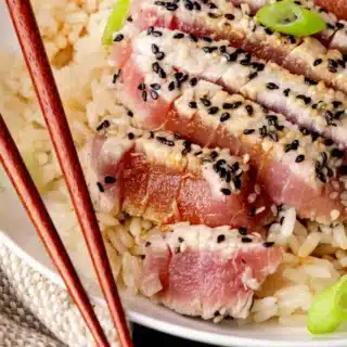 Seared ahi on dinner plate with rice.