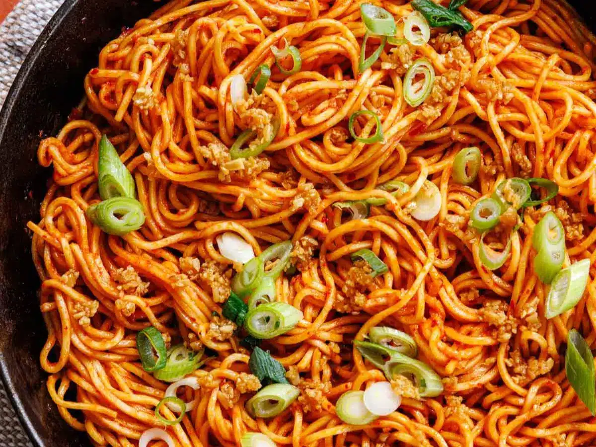 Cooked and garnished noodles in pan