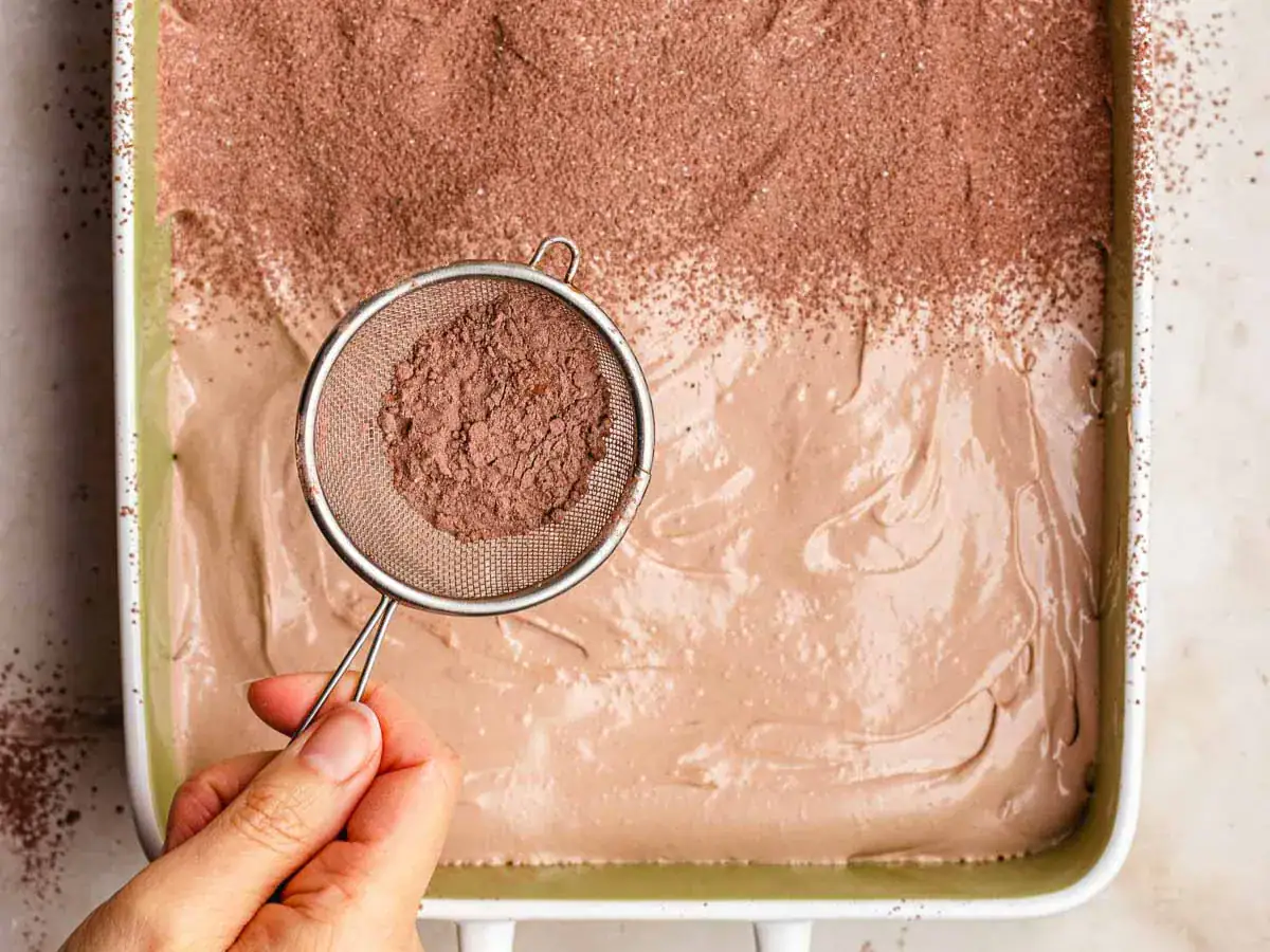 Cocoa powder and sugar mixture sprinkled on top of sweet confection.