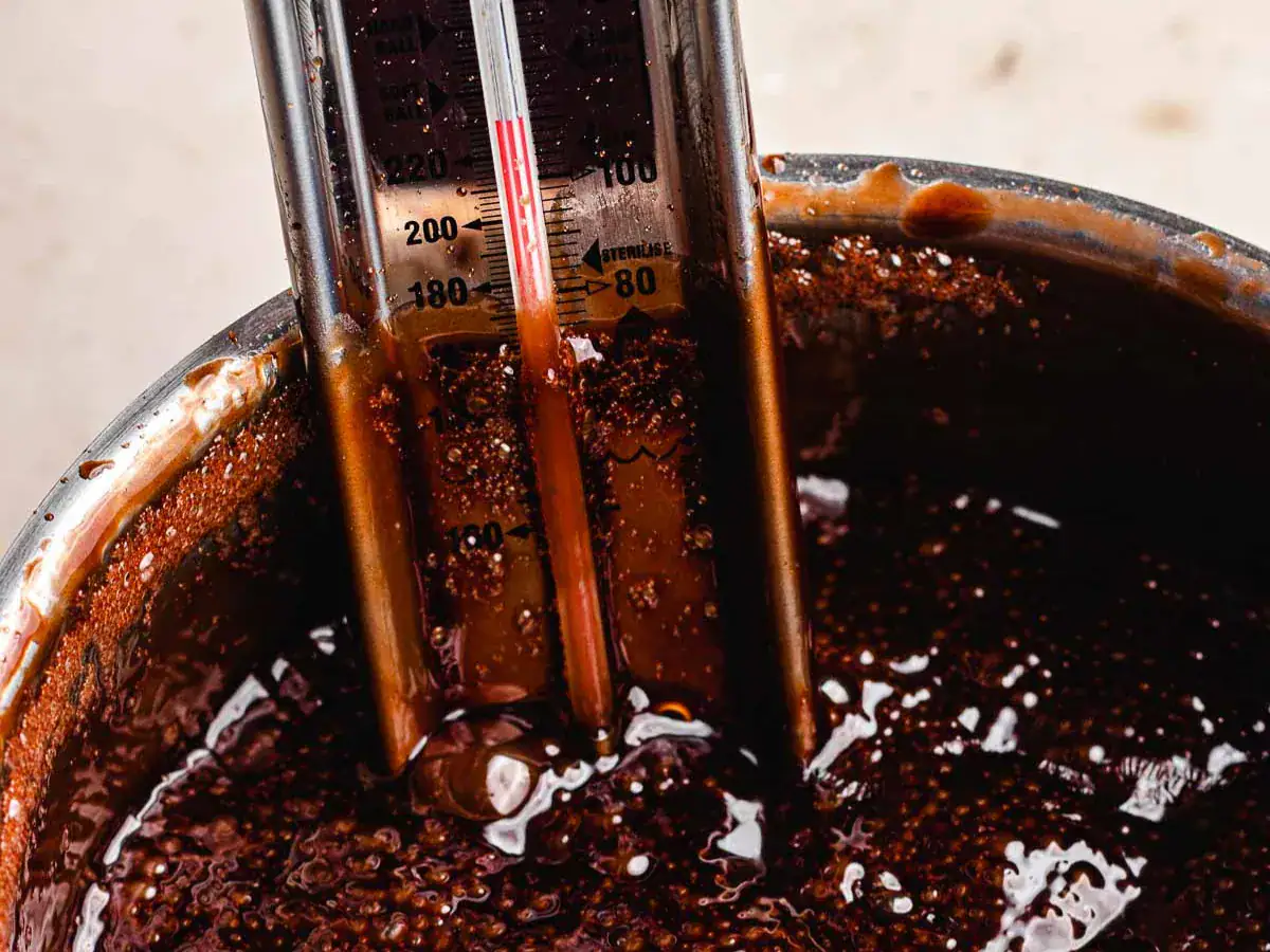 Corn syrup, sugar, and cocoa powder boiling in pot.