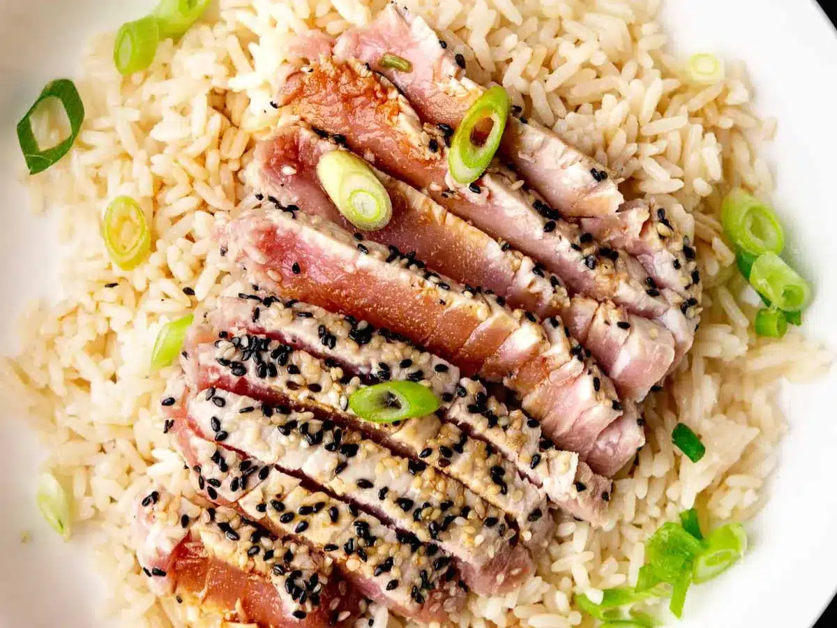 Seared ahi on dinner plate with rice.