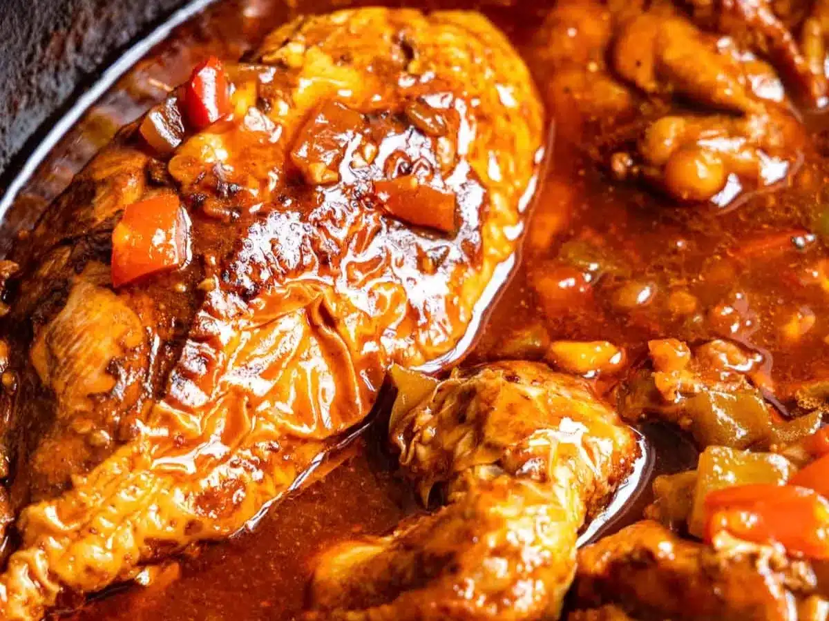 Close up of skin on chicken in thick broth.