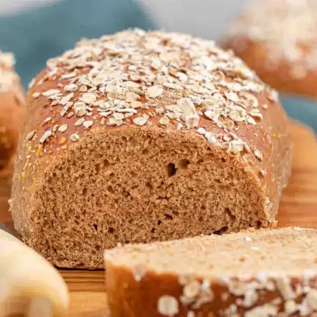 Loaf of bread with piece sliced off of it.