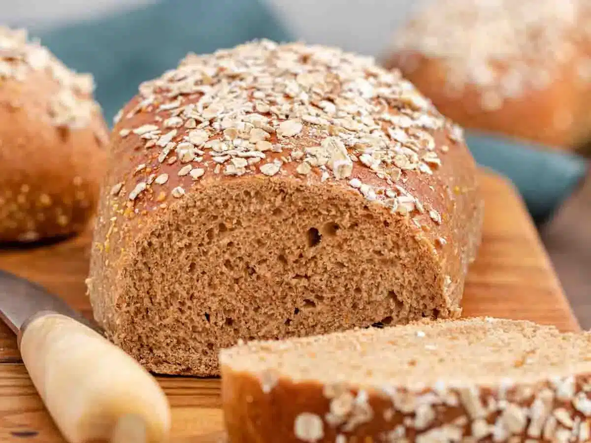 Loaf of bread with piece sliced off of it.