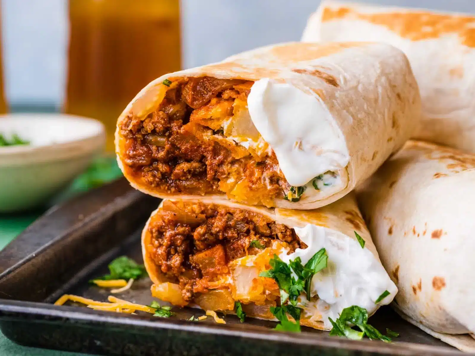 Burrito cut in half on dinner plate.