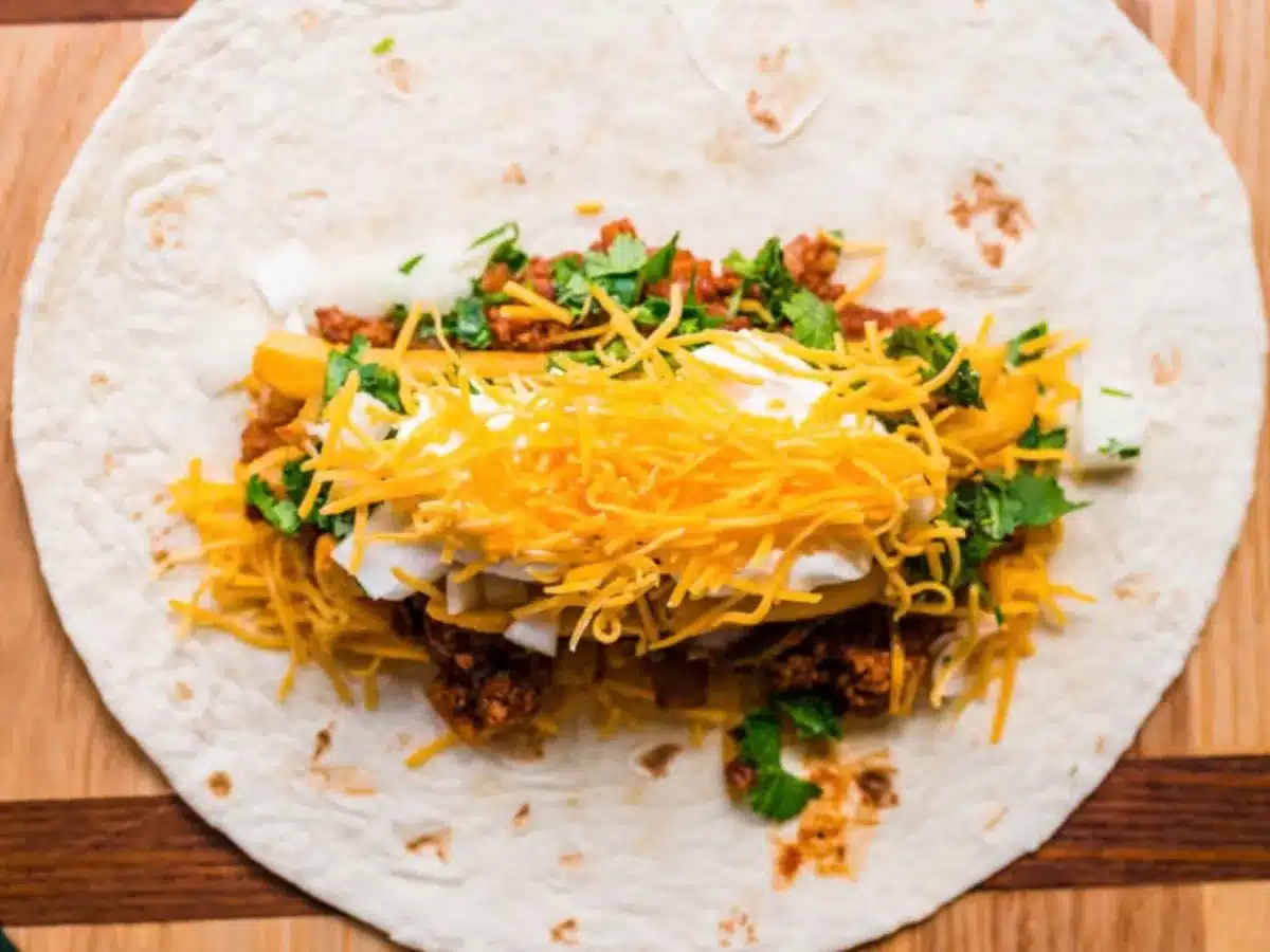 Ground meat, cheese, sour cream, and fries piled on tortilla.
