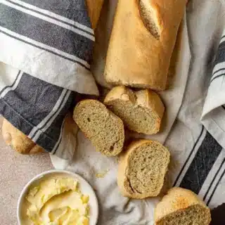 Loaf of baked bread cut into slices.