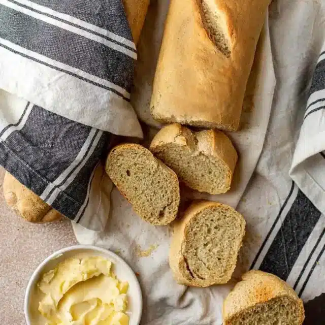Loaf of baked bread cut into slices.