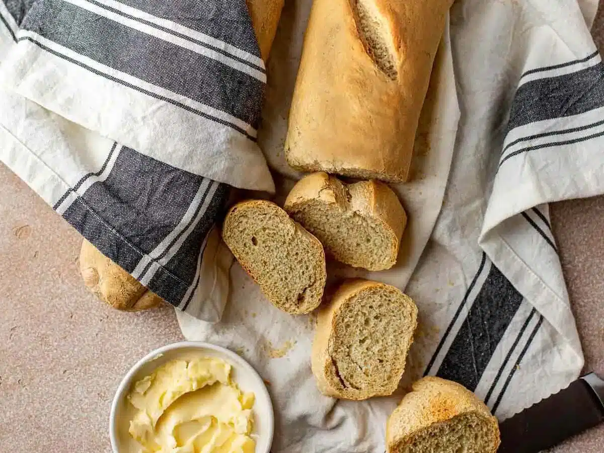 Loaf of baked bread cut into slices.
